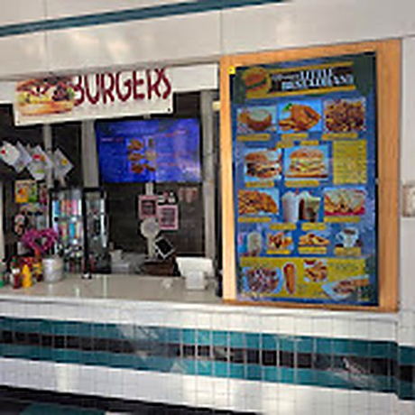The Miriam's Little Restaurant counter inside the Broadway food court, with the burger sign and menu boards above